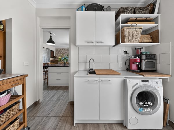 Bright and functional laundry area featuring modern appliances and ample storage for convenience and organization.