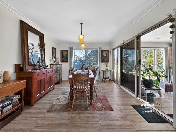 Spacious dining area featuring natural light, attractive décor, and easy access to a vibrant outdoor space.