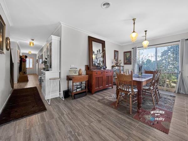 Spacious dining area featuring natural light and direct access to a beautifully landscaped outdoor space.