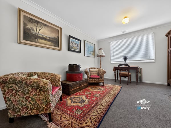 Bright and inviting living area featuring vintage decor, warm textiles, and ample natural light.