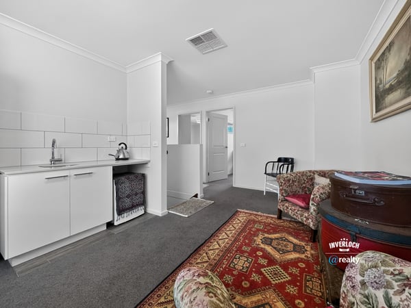 Spacious living area with kitchenette and versatile layout, perfect for personalized interior design and cozy gatherings.