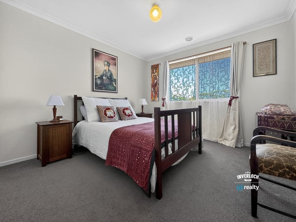 Bright bedroom featuring comfortable furnishings and ample natural light, ideal for relaxation and rest.