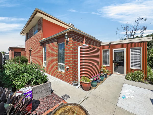 This distinctive home features a unique design, spacious garden, and ample natural light throughout.