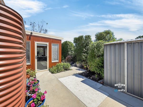 This property showcases a unique outdoor space with vibrant landscaping and modern design elements.
