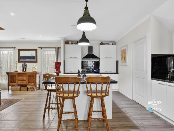 Modern kitchen with ample storage, featuring a central island and inviting dining area for casual meals.