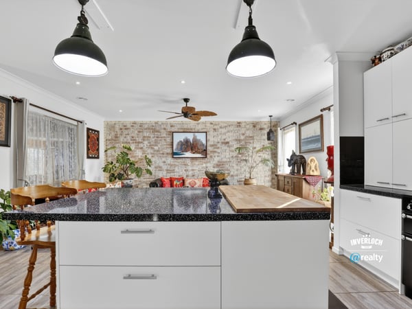 Inviting open-concept kitchen and living area featuring modern finishes and a cozy atmosphere for gatherings.
