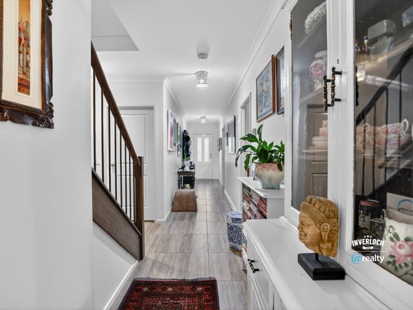 Discover a modern hallway featuring natural light, tasteful decor, and a welcoming ambiance throughout.