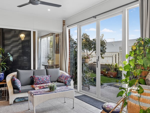 Bright and airy sunroom featuring large windows, perfect for relaxation and enjoying views of the garden.