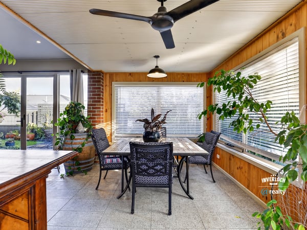 Bright and airy sunroom features large windows, perfect for enjoying peaceful views and entertaining guests.