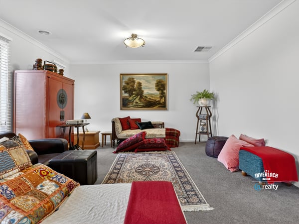Spacious living area featuring diverse seating options and artwork, perfect for relaxation and gatherings.