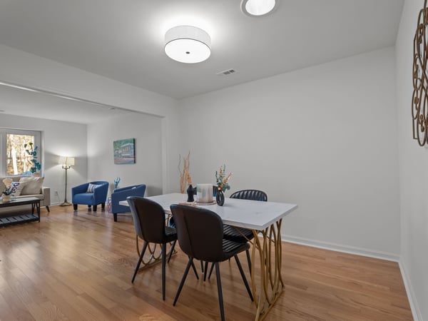 Dining room with new light fixture and hardwood floors