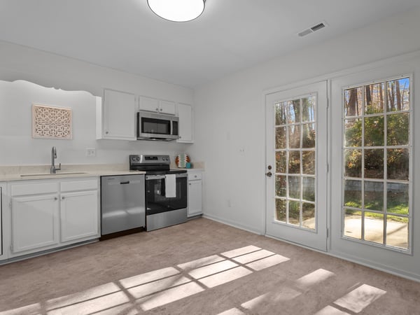 Kitchen includes painted cabinets and brand new stainless steel appliances
