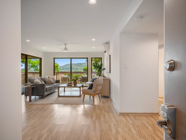 Spacious living area with large windows provides breathtaking views and seamless indoor-outdoor living experience.