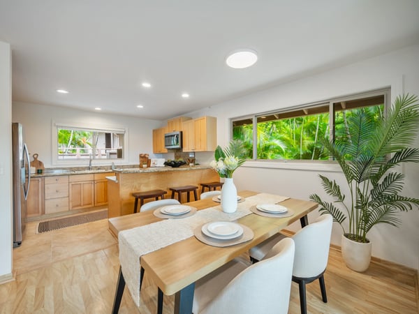 Bright and inviting kitchen features modern appliances, ample counter space, and a cozy dining area.