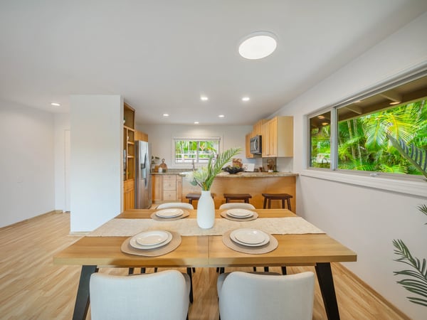 Bright and inviting kitchen with modern appliances, a spacious dining area, and lush garden views.
