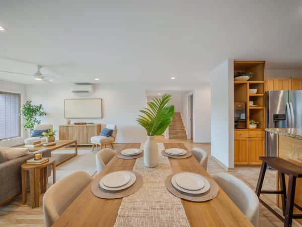 Bright, open-plan living area featuring modern furnishings and a seamless flow into the kitchen and dining spaces.