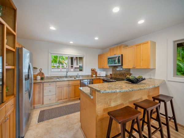 Modern kitchen featuring granite countertops, ample storage, and an open layout, perfect for entertaining.