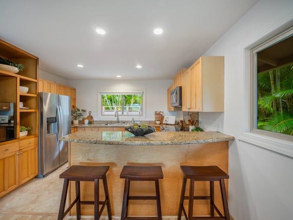 Modern kitchen featuring granite countertops, stainless steel appliances, and an inviting breakfast bar for casual dining.