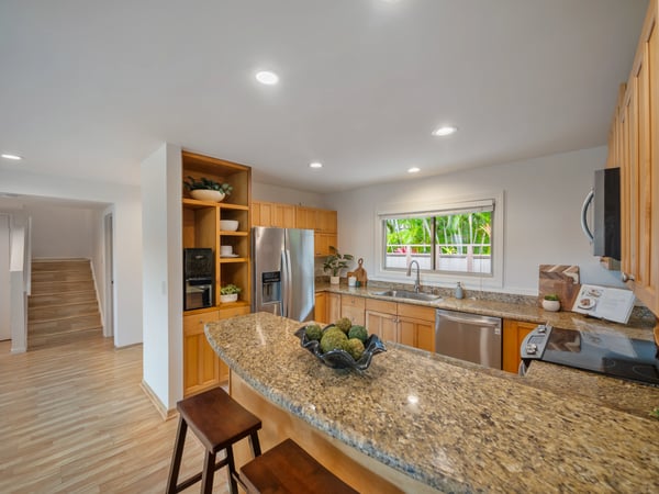 Bright kitchen featuring modern appliances, ample counter space, and a welcoming atmosphere for gatherings.