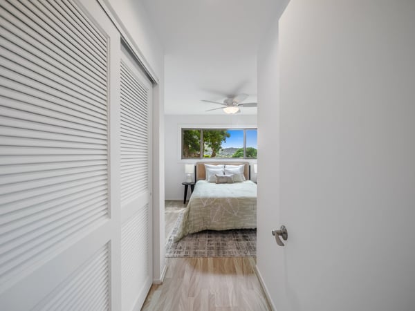 Modern bedroom featuring large windows, providing ample natural light and a refreshing outdoor view.