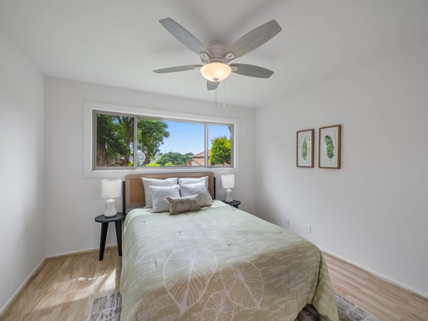 Bright and inviting bedroom featuring large windows, modern fixtures, and thoughtful decor for comfort and tranquility.