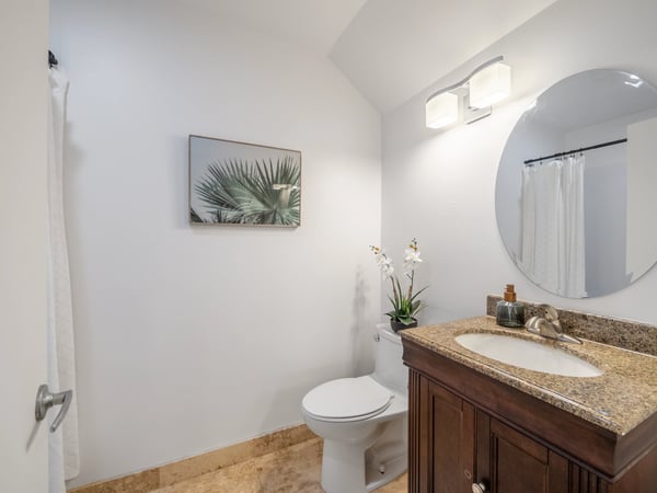 Bright and inviting bathroom featuring modern fixtures, a large mirror, and tasteful decor accents.