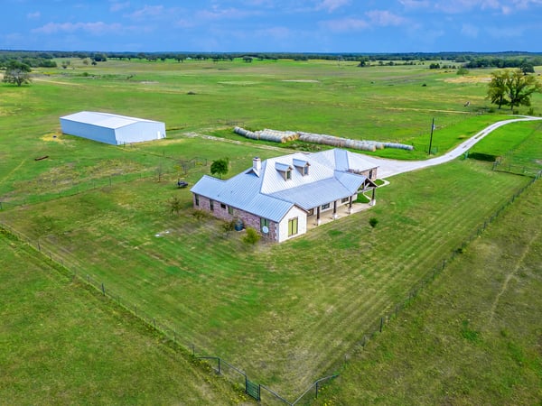 PROPERTY AERIAL...View Of Home And Livestock/Equipment Bldg Combo