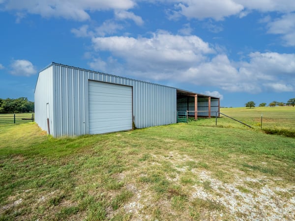 OUTBUILDING...Enclosed Side Is 40x50 W/Concrete Slab And 2 Overhead Doors. Livestock Area Is 50x60 W/Dirt Floor