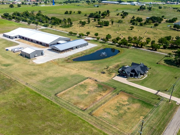 PROPERTY AERIAL...Extra View Of Custom Home, 2 Show Barns, Huge Covered Arena And Outbuilding