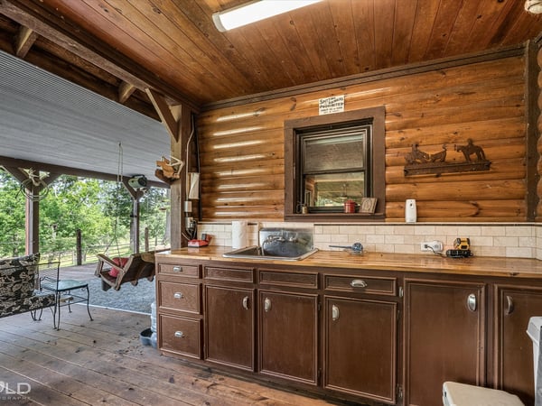 Enjoy rustic charm in this inviting kitchen space, perfect for entertaining on the covered patio.