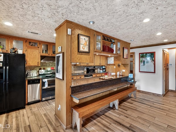 This inviting kitchen features ample cabinetry, modern appliances, and a cozy breakfast bar for casual dining.