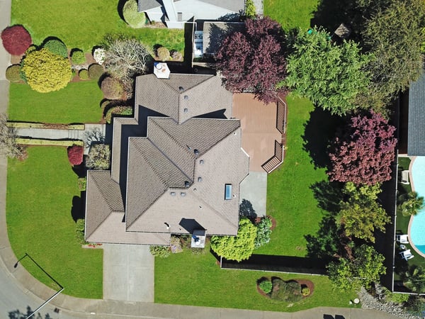 Spacious home with extensive landscaping, featuring multiple outdoor living areas and proximity to community amenities.