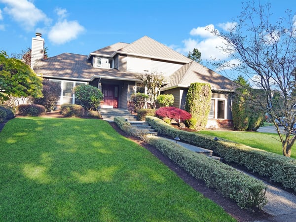 Spacious home with well-maintained landscaping, featuring a unique architectural design and ample outdoor space for entertaining.