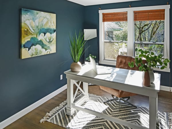 Bright home office featuring large windows, and a calming color palette for productivity.