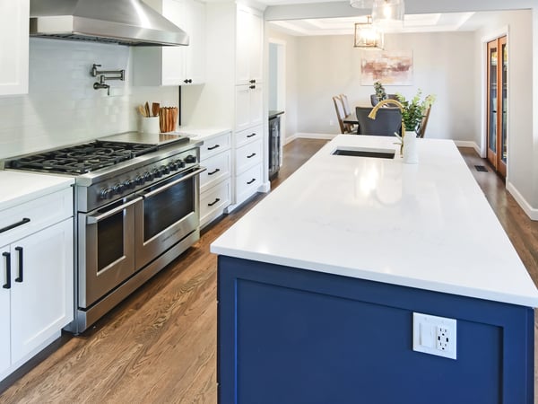 Modern kitchen featuring a large island, high-end appliances, and a seamless flow into the dining area.