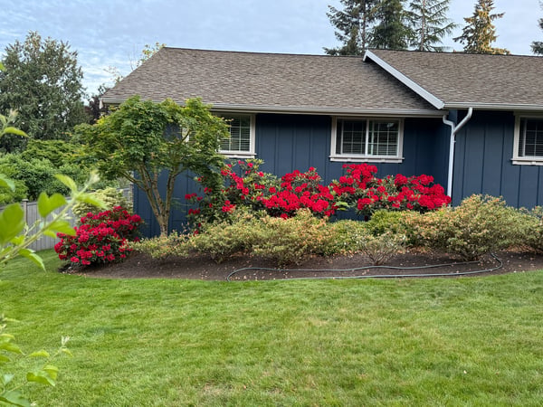 Brightly colored azaleas enhance the lush, landscaped grounds of this inviting home in a tranquil setting.