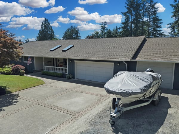 Spacious home featuring a large driveway, boat parking, and attractive landscaping in a vibrant neighborhood.