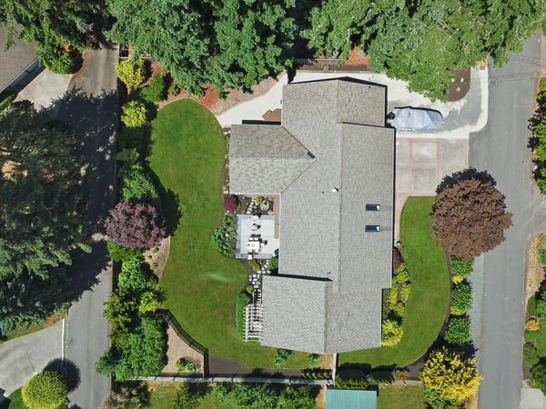 Discover this spacious home surrounded by lush greenery, featuring a large yard perfect for outdoor gatherings.