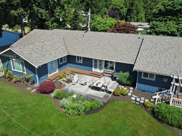 Spacious outdoor patio surrounded by vibrant landscaping offers ideal space for relaxation and gatherings.