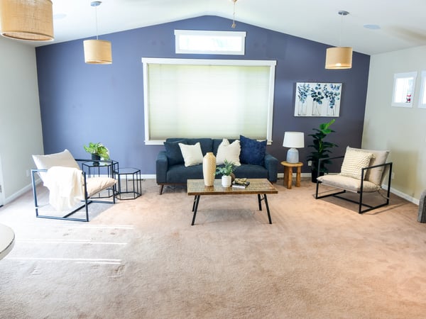 Spacious living area featuring modern furnishings, abundant natural light, and a comfortable atmosphere for relaxation.