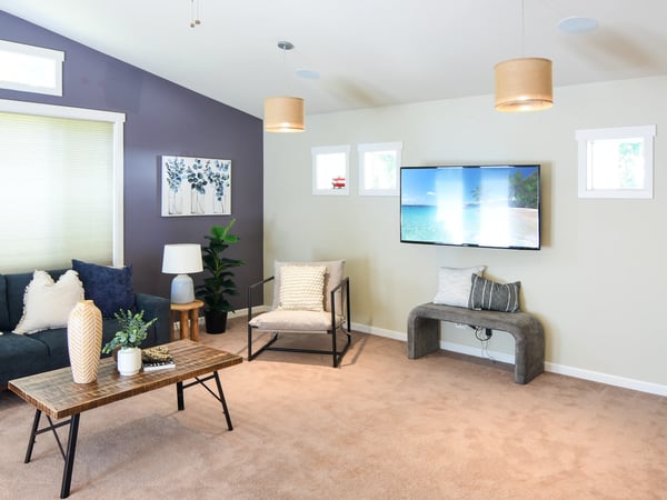 Bright and inviting living area featuring modern decor, ample natural light, and a comfortable layout for relaxation.