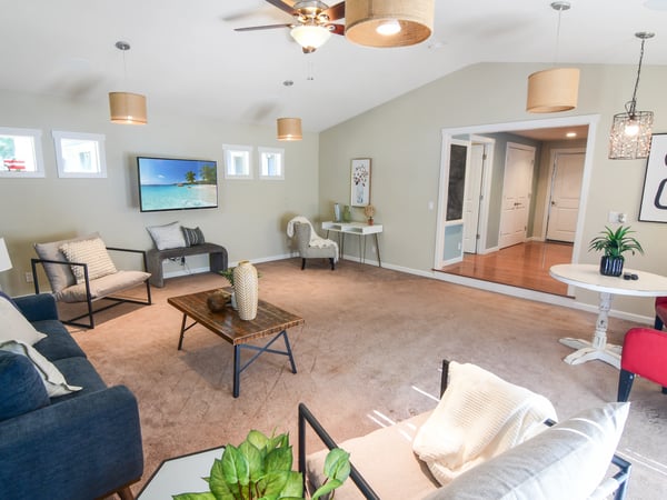 Spacious living area featuring modern decor, abundant natural light, and seamless flow into adjacent rooms.