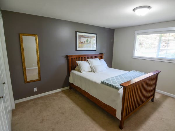 Spacious bedroom featuring natural light, ample storage, and a cozy atmosphere for peaceful relaxation.