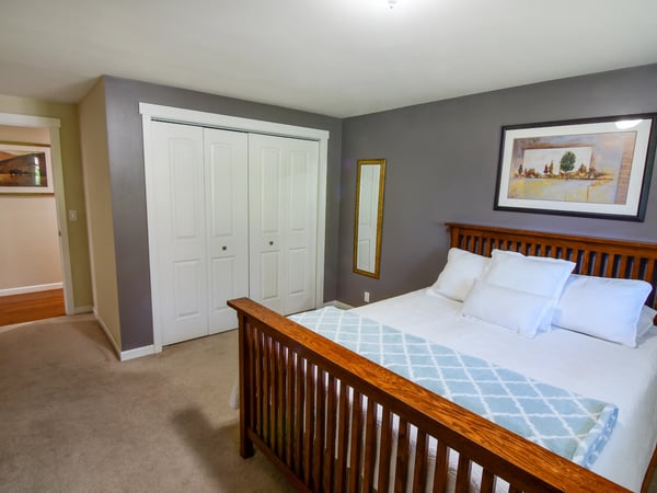 Bright and inviting bedroom featuring ample storage, modern decor, and a cozy atmosphere for relaxation.