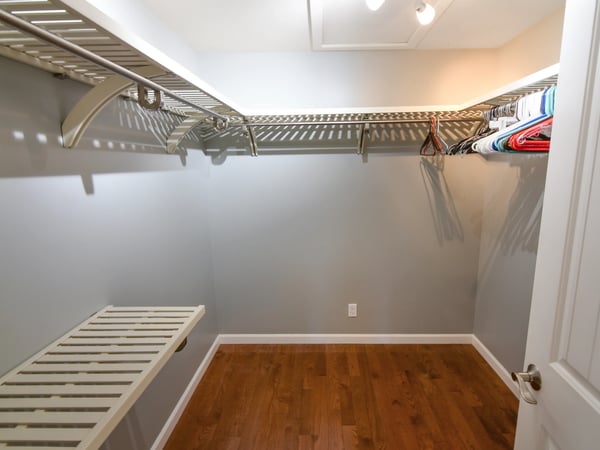 Spacious walk-in closet featuring ample shelving and hanging space, perfect for organized storage solutions.