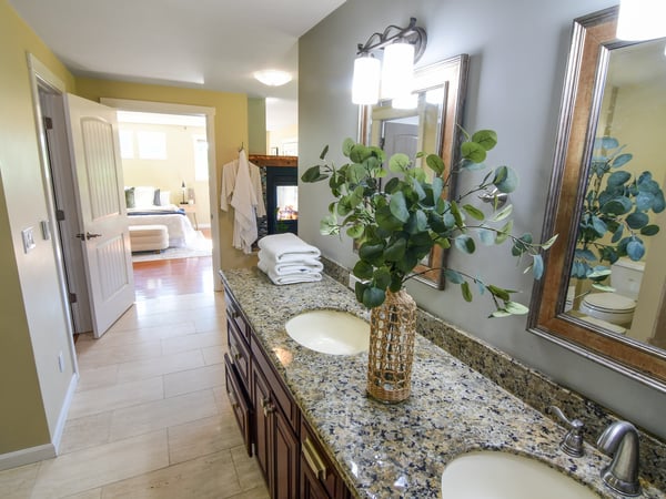 Spacious bathroom featuring dual sinks, modern finishes, and natural light, enhancing everyday functionality and comfort.
