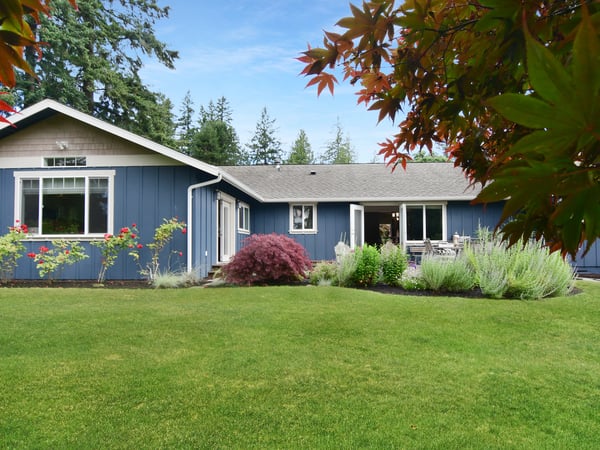 Discover this inviting home with lush landscaping and a spacious yard, perfect for outdoor gatherings.