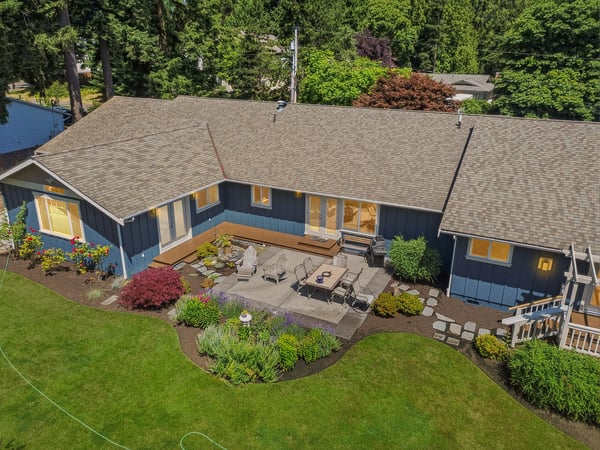 Spacious outdoor patio surrounded by vibrant landscaping, perfect for entertaining and enjoying nature’s beauty.