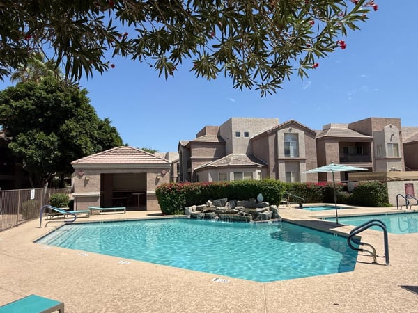 Resort-inspired pool area with ample space to relax, unwind, and enjoy Arizona sunshine. Community amenities include swimming pools, heated lap pool, spas, and gathering areas.