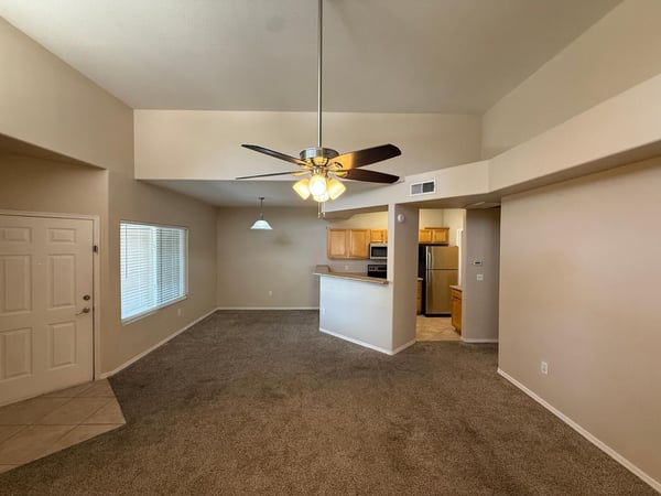 Light-filled great room with soaring ceilings and generous living space. The open design creates an airy atmosphere while maximizing functionality and comfort.